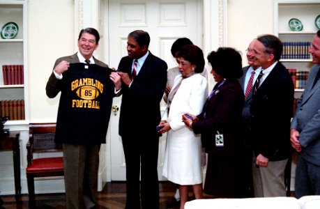 President Ronald Reagan during a photo op. with Coach of Grambling State university football team Eddie Robinson in the Oval Office photo