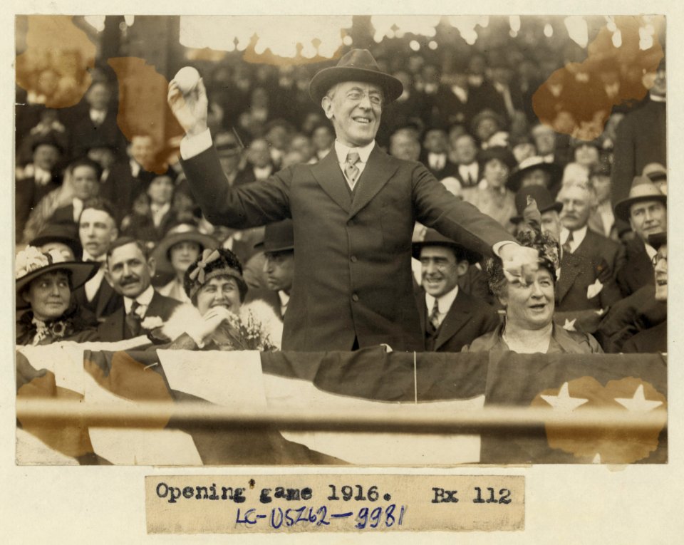 President Woodrow Wilson throwing out the first ball, opening day, 1916; among those present are Edith Bolling Galt Wilson and Mrs. John A. (Ida) Wilson LCCN97518727