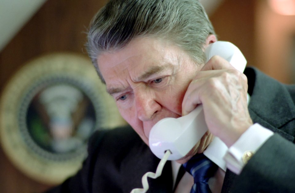 President Ronald Reagan talking on the telephone about the Highway bill aboard Air Force One
