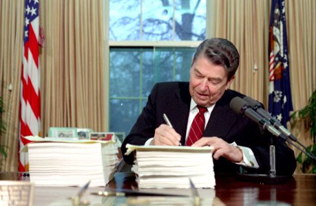 President Ronald Reagan during the signing ceremony for the Continuing Resolution and Reconciliation Bill in the Oval Office
