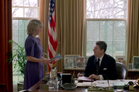 President Ronald Reagan talking with secretary Kathy Osborne in the Oval Office photo