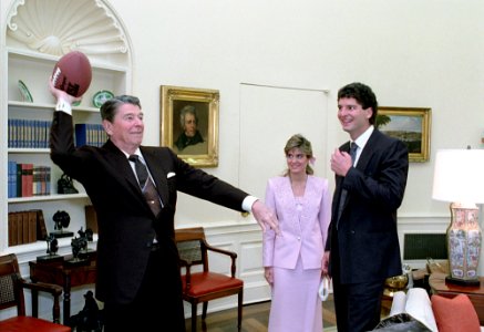 President Ronald Reagan throwing a football during a photo op with football player Bernie Kosar of the Cleveland Browns photo