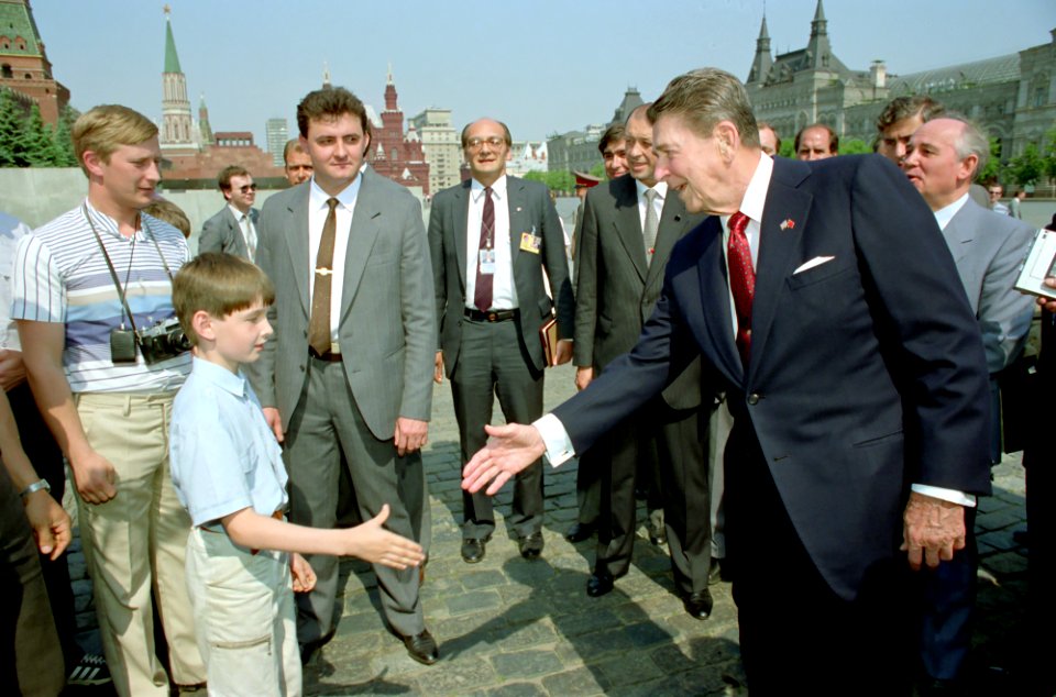 President Ronald Reagan greets a young boy while touring Red Square during the Moscow Summit in the USSR