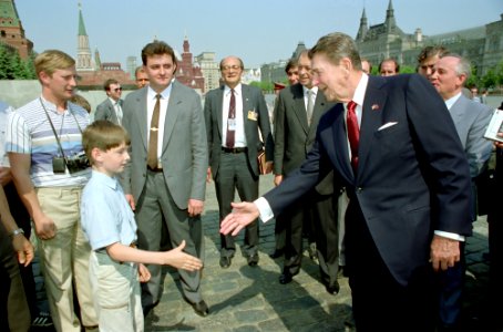 President Ronald Reagan greets a young boy while touring Red Square during the Moscow Summit in the USSR
