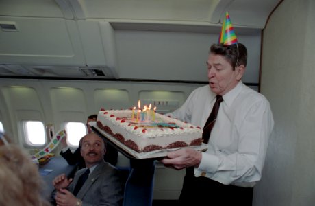 President Ronald Reagan holding a birthday cake