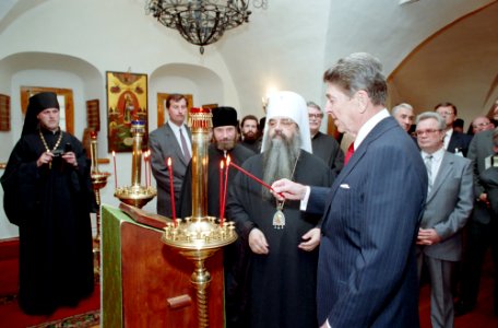 President Ronald Reagan lights candles during a visit to Danilov Monastery in Moscow