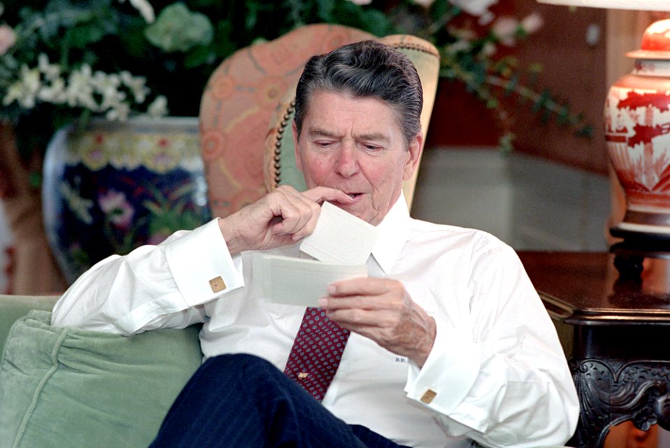 President Ronald Reagan looking at 3x5 speech cards