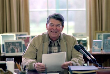President Ronald Reagan making a radio address to the nation on tax reform and the nation's farmers in the Oval Office photo