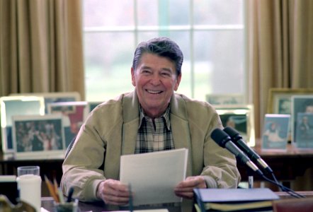 President Ronald Reagan making a radio address to the nation on tax reform and the nation's farmers in the Oval Office
