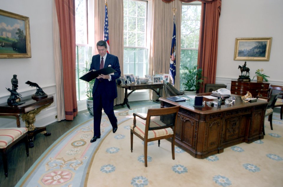 President Ronald Reagan working alone in the Oval Office