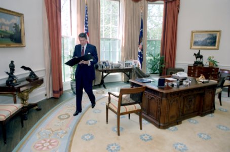 President Ronald Reagan working alone in the Oval Office photo