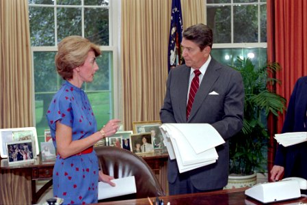 President Ronald Reagan working in the Oval Office with Pamela Turner photo