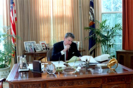 President Ronald Reagan working on the State of the Union Address at his oval office desk photo