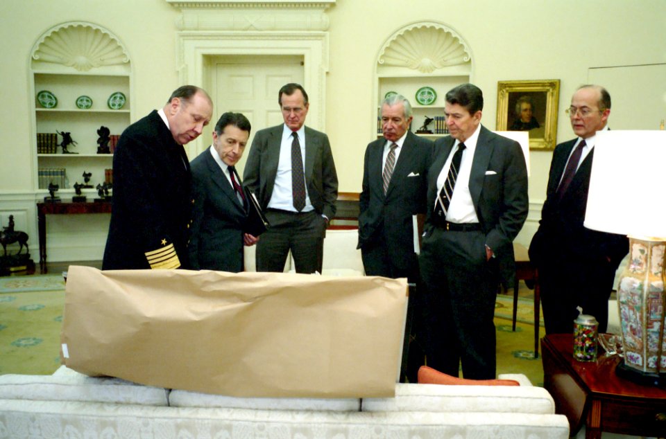 President Ronald Reagan meeting with George H. W. Bush, Don Regan, John Poindexter, Caspar Weinberger, and William Crowe regarding Libya in the Oval Office