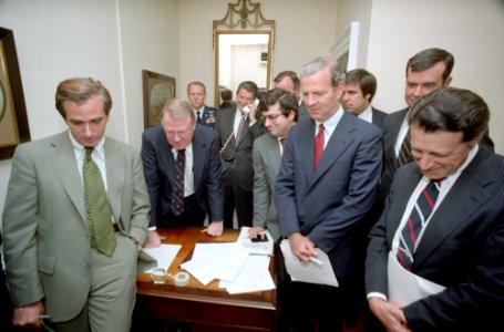 President Ronald Reagan, Ken Duberstein, George H. W. Bush, Ed Meese, Craig Fuller, Richard Darman, James Baker, Caspar Weinberger, and William Clark watching the Tax Bill vote with staff