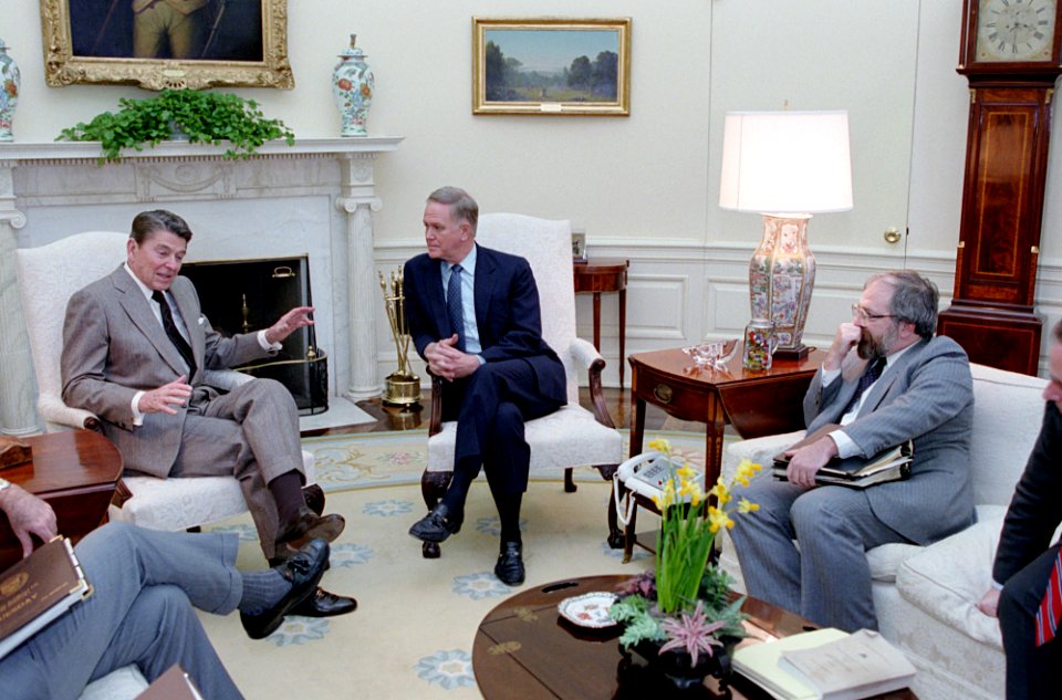 President Ronald Reagan meeting with Senator Bob Packwood to discuss Tax Reform with Bill Diefenderfer, Don Regan and William Ball in the Oval Office