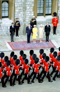 President Ronald Reagan, Nancy Reagan, Queen Elizabeth II, Prince Philip, and Prince Charles reviewing troops at Windsor Castle during trip to the United Kingdom