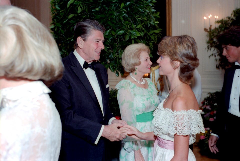President Ronald Reagan shaking hands with Olivia Newton-John