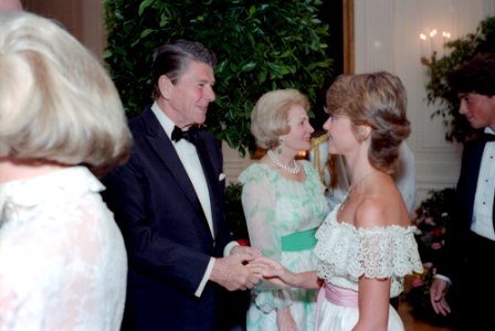 President Ronald Reagan shaking hands with Olivia Newton-John photo