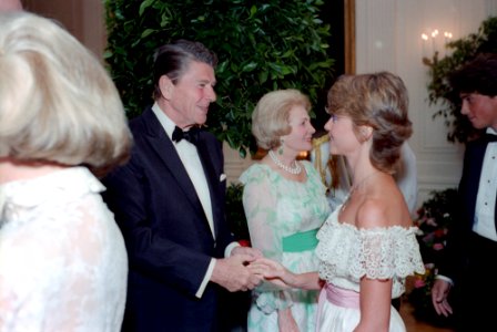 President Ronald Reagan shaking hands with Olivia Newton-John