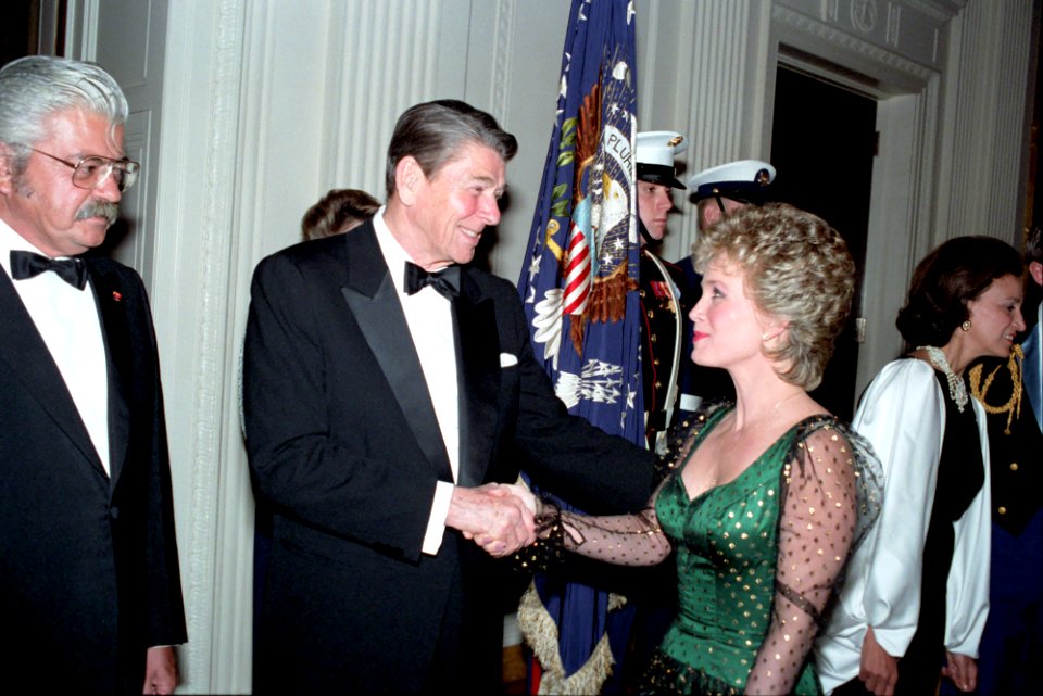 President Ronald Reagan shaking hands with singer Barbara Mandrell