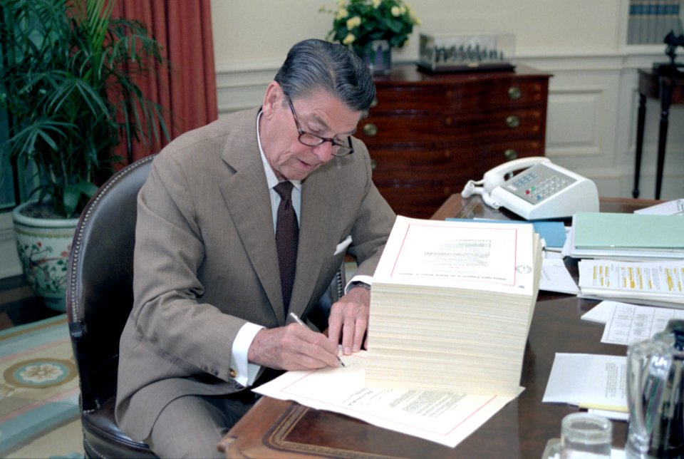 President Ronald Reagan signing H.R. 4170 the Deficit Reduction Act of 1984 in the Oval Office