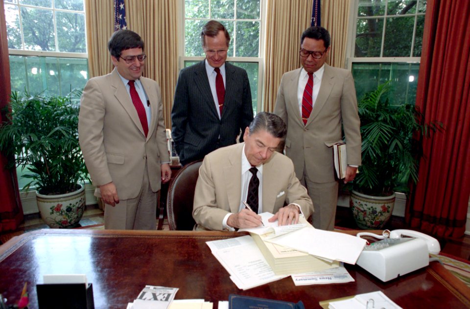 President Ronald Reagan signing veto of defense authorization bill