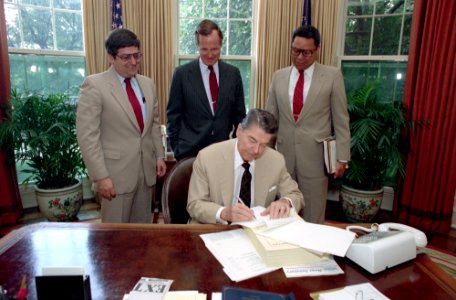 President Ronald Reagan signing veto of defense authorization bill
