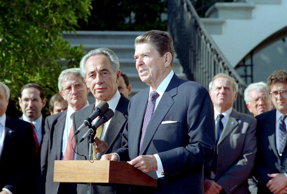 President Ronald Reagan speaking at a podium during a working visit of Prime Minister Shimon Peres of Israel