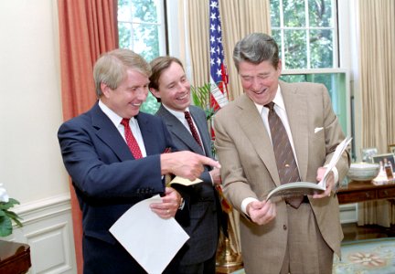 President Ronald Reagan talking with Jim Kuhn and Larry Speakes in the Oval Office