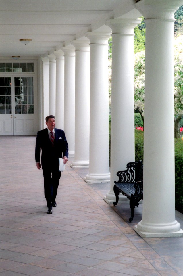 President Ronald Reagan walking along the colonnade the morning after the Libya air strike