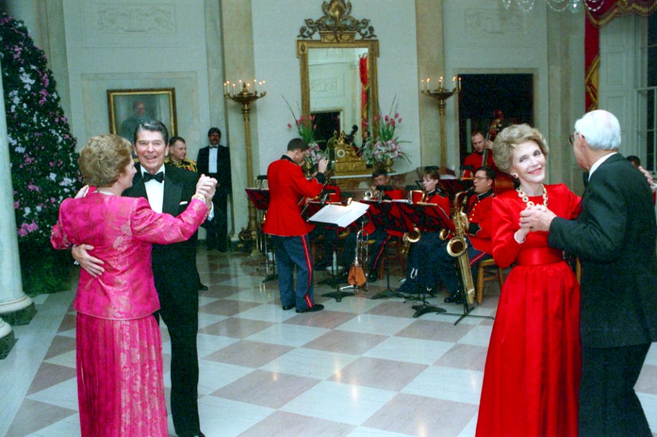 President Ronald Reagan, Margaret Thatcher, Nancy Reagan, and Denis Thatcher dancing in the Cross Hall