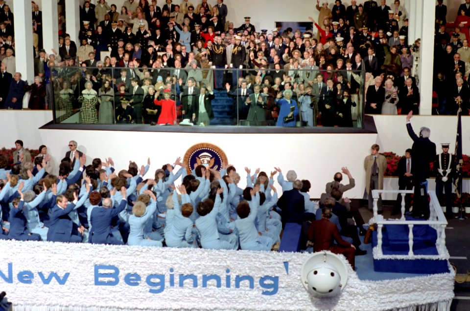 President Ronald Reagan, Nancy Reagan, Omar Bradley, Ron Reagan, Patti Davis, George W. Bush, Barbara Bush, and George H W Bush in the Inaugural Parade viewing stands as the Mormon Tabernacle Choir passes by