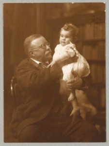 President Roosevelt, seated, holding an infant grandchild LCCN2009631453 photo