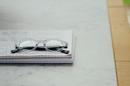 Eyeglasses gray paper gray table photo