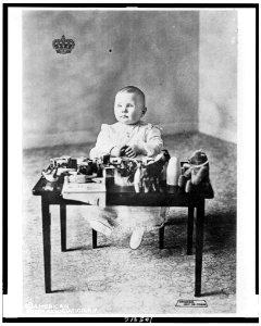 Princess Juliana, future queen of the Netherlands, full-length portrait, seated, facing slightly left, at small table, with toys LCCN92512408