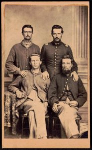 Private Thornton Reber and Lieutenant Thomas Griffith of Co. I, 159th Ohio Infantry Regiment, standing, and two unidentified soldiers, seated, in Union uniforms) - Photographed by A. LCCN2016646214