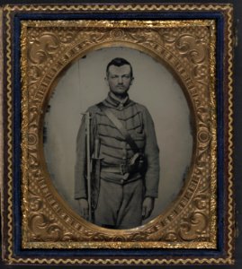 Private John G. Lee of Company H, 18th Virginia Infantry Regiment, with bayoneted musket, large Bowie knife, and percussion pistol LCCN2011661455