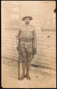 Private Juneous H. Knox in uniform and campaign hat with rifle and knife hanging from cartridge belt LCCN2017648695