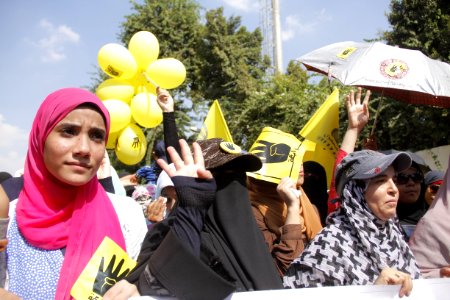 Protesters hold up four fingers as R4bia sign in Maadi-Cairo 20-Sep-2013