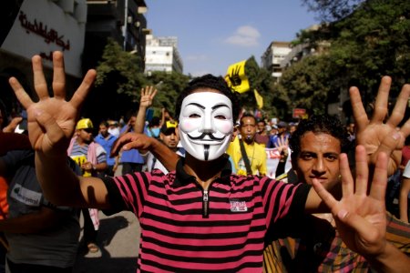 Protester with Guy Fawkes mask making R4bia sign Maadi-Cairo 20-Sep-2013