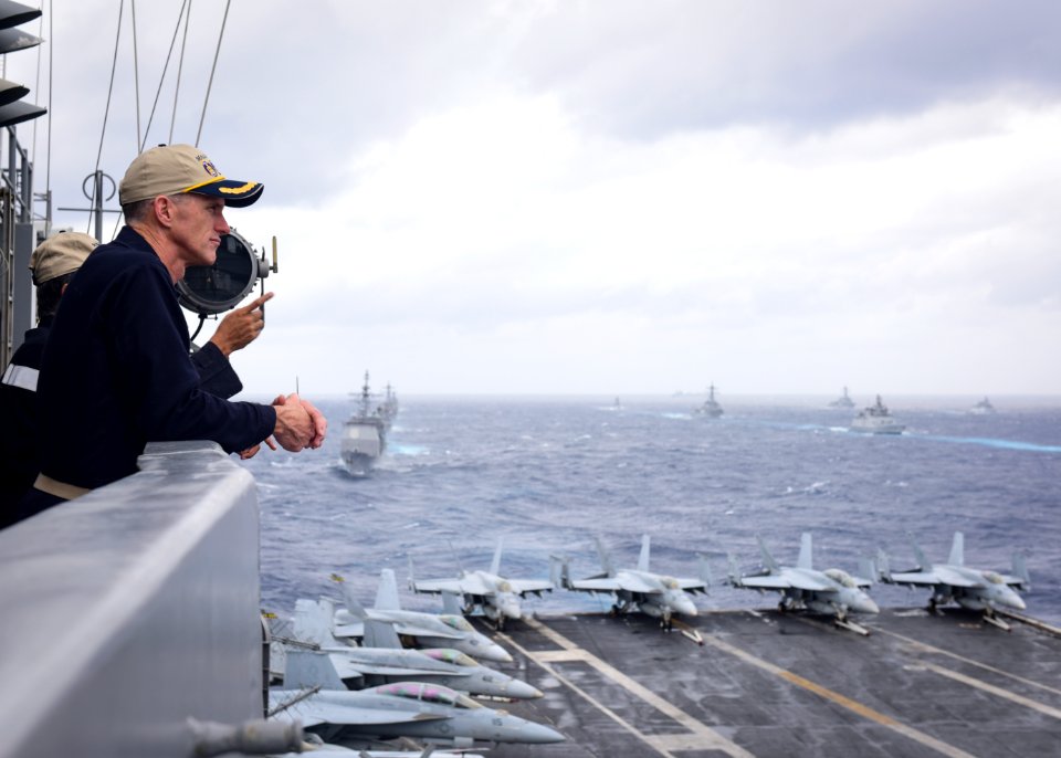 Rear Adm. Bill Byrne, commander of Carrier Strike Group 11, watches ships from the Indian navy, Japan Maritime Self-Defense Force (JMSDF) and the U.S. Navy sail in formation in the Bay of Bengal