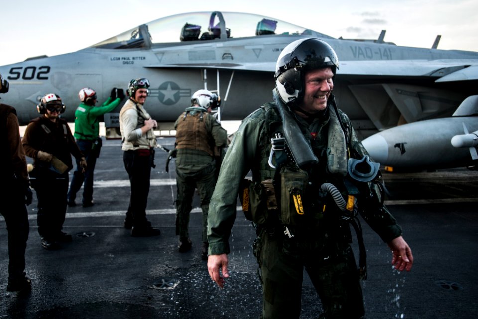 Rear Adm. is soaked with water after being doused with a fire hose in celebration of his final arrested landing aboard the USS Ronald Reagan. (28434293485)