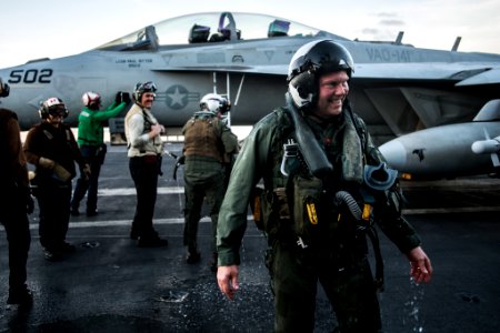 Rear Adm. is soaked with water after being doused with a fire hose in celebration of his final arrested landing aboard the USS Ronald Reagan. (28434293485)