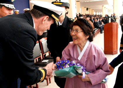 Rear Adm. McQuilkin gives flowers to Hong Eun-Hye. (8510386418)
