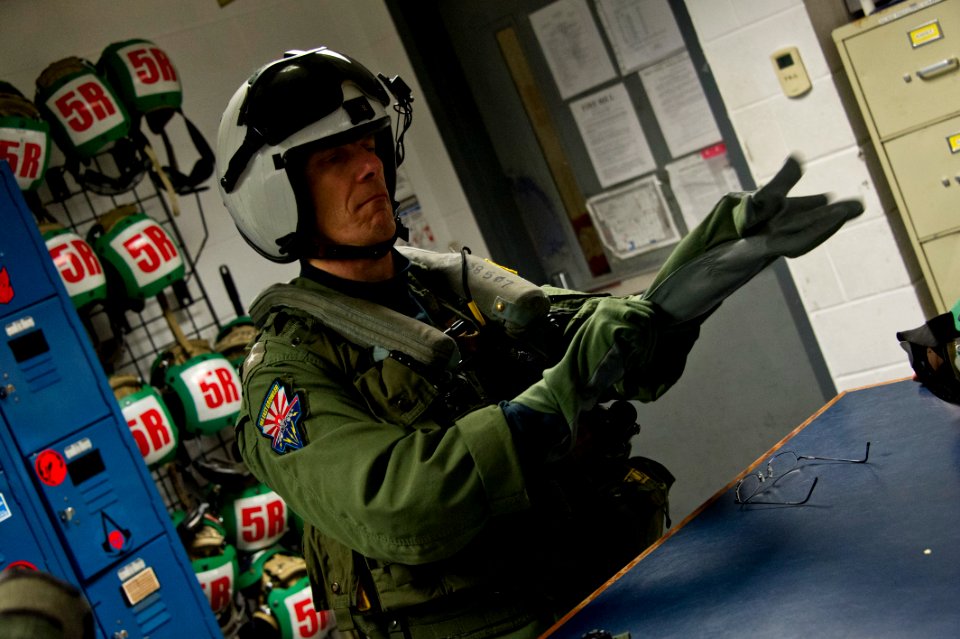 Rear Adm. J.R. Haley ons his flight suit before flying in an MH-53E Sea Dragon helicopter. (16733674425)