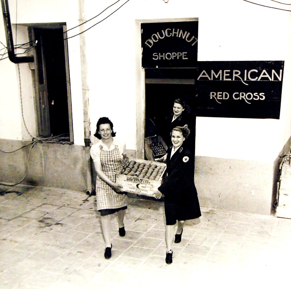 Red Cross girls carrying fresh doughnuts from an improvised kitchen, Constantine, Algeria, 1943 (27503466272)