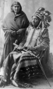 Red Cloud & wife. (seated, in regalia, holding pipe) LCCN2016647630 (cropped)
