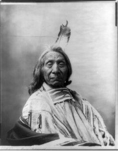 Red Cloud, Chief, head and shoulders portrait, facing slightly right, wearing one feather LCCN2006682633