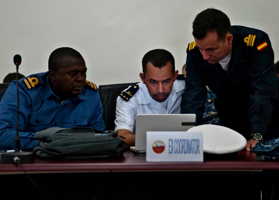 Republic of Sierra Leone Armed Forces Lt. Mark Sumah; Mauritanian Navy Lt. Ahmed Salem Maouloud, the coordinator for Saharan Express 2014; and Spanish Navy Lt. Cmdr. Antonio de Ugarte Blanco work together 140310-N-QY759-054